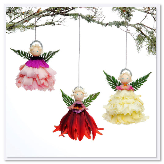 A Colourful trio of angels greeting card delicately crafted from fresh flowers on a white background. Size 142 x 142 mm. Found at Golly Gosh Creations.
