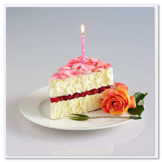Floral cake slice made of pink rose petals, white blooms, and red flowers with lit birthday candle on white plate, coral rose garnish.