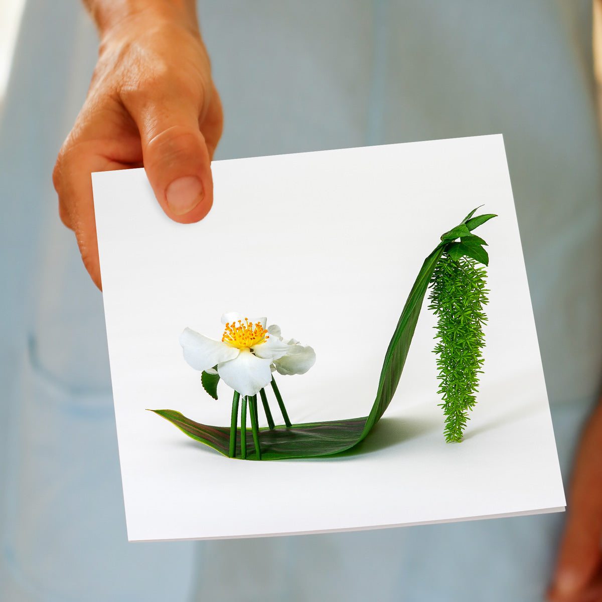 Image of a hand held elegant camellia stiletto shoe greeting card from Golly Gosh Creations. Handcrafted floral design on a white background. Size 142 x 142 mm