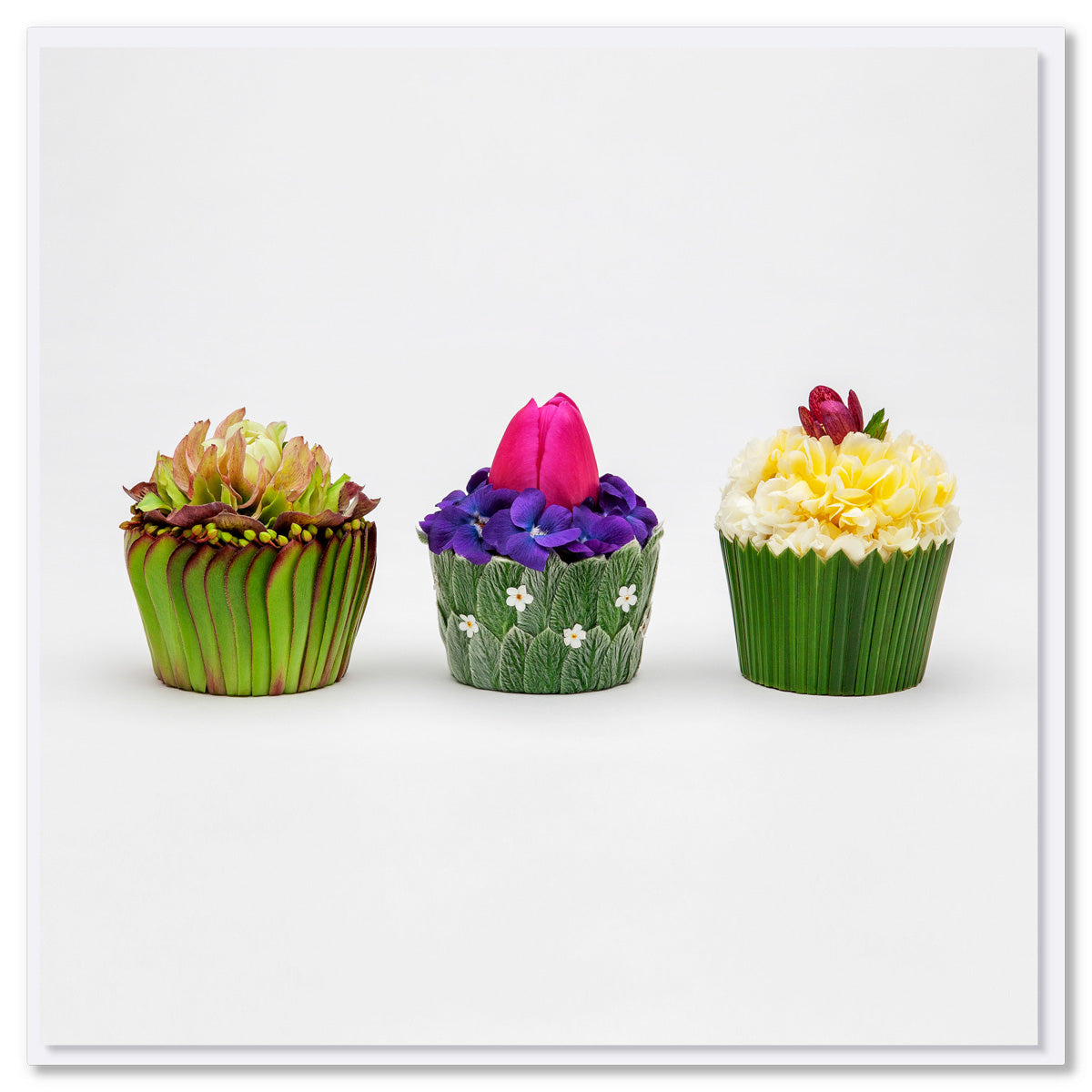 A delightful floral cupcakes greeting card. 3 individual cupcakes created from dainty flowers and soft leaves. A quality square card found at Golly Gosh Creations.