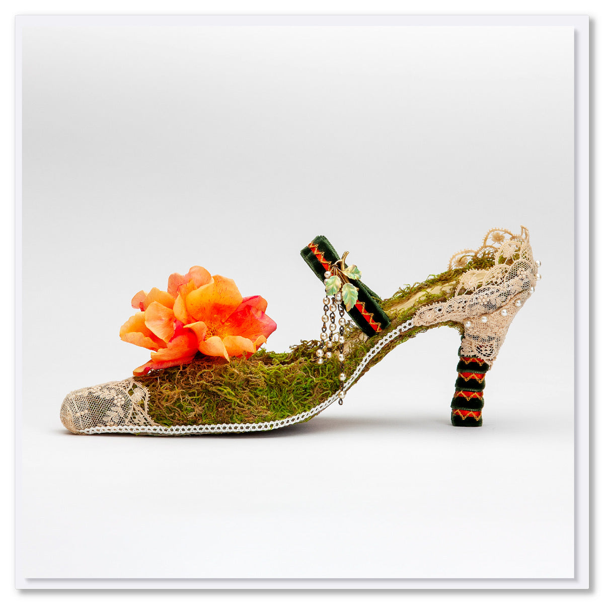 An exquisite lace heel shoe greeting card from Golly Gosh Creations. This quality square card is adored with moss, lace and a vibrant orange flower.
