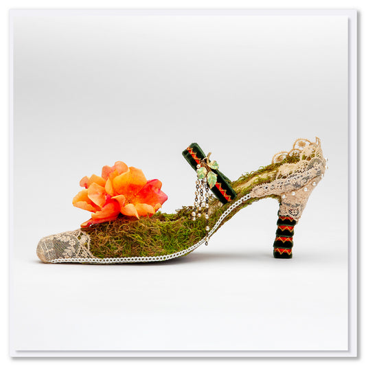 An exquisite lace heel shoe greeting card from Golly Gosh Creations. This quality square card is adored with moss, lace and a vibrant orange flower.