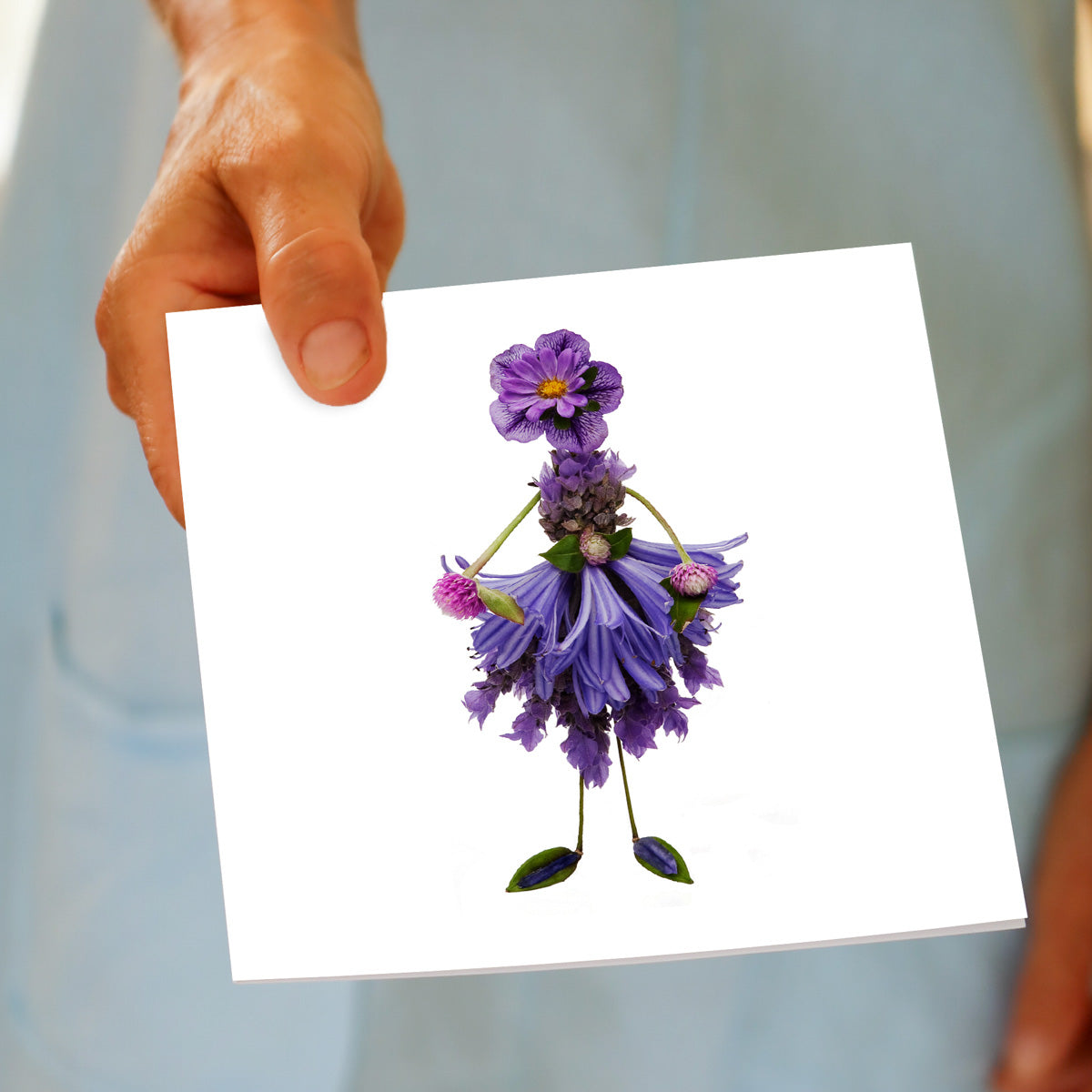 A lavender lady greeting card being held by hand. Available at Golly Gosh Creations. An elegant card created from fresh lavender. Size 142 x 142 mm.