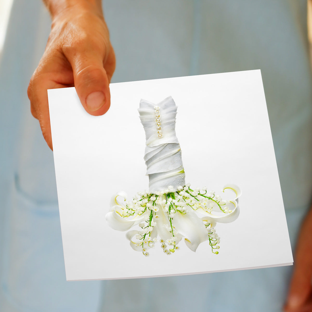 A hand held lily of the valley dress greeting card from Golly Gosh Creations. A generous square card created from the pretty white flower.