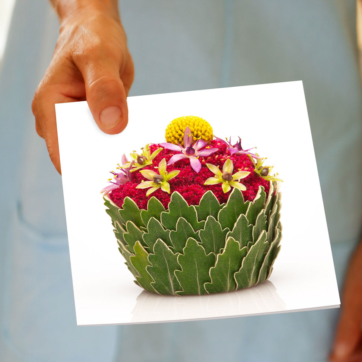 A hand held pineapple cupcake greeting card from Golly Gosh Creations. Size 142 x 142 mm. A pretty card crafted from dainty pineapple flowers and greenery.