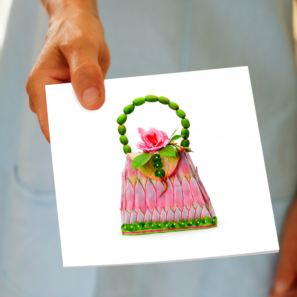 A hand held pink king protea greeting card from Golly Gosh Creations. Size 142 x 142 mm. An elegant card crafted from elongated pink king protea petals.