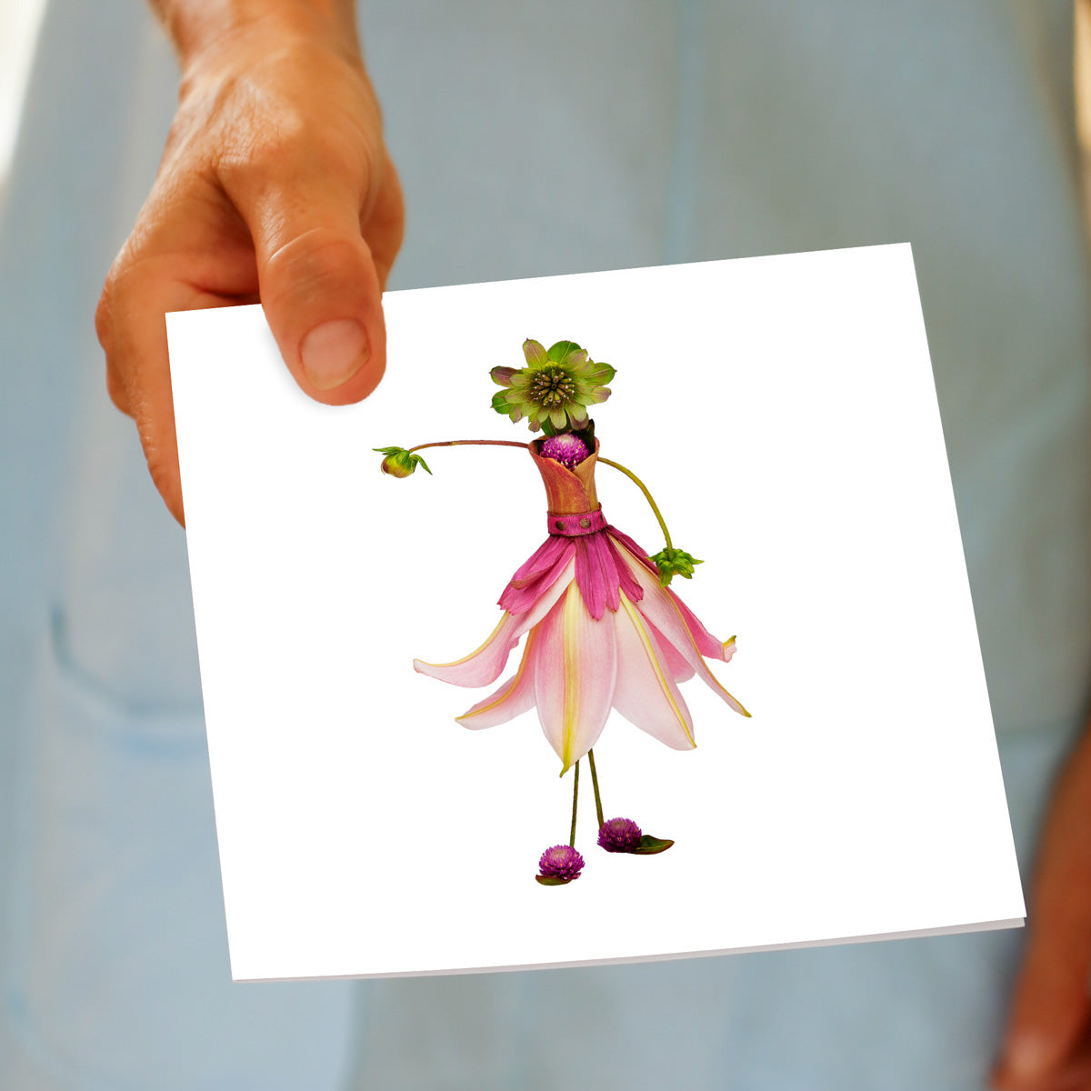 A hand held pink lily ballerina greeting card from Golly Gosh Creations. This generous square card is crafted from delicate lily petals, blooms and buds.