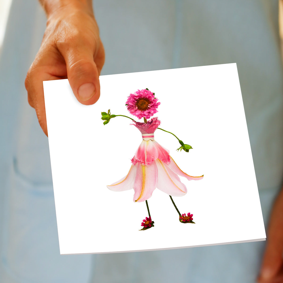 A  hand held pink lily girl greeting card from Golly Gosh Creations. Size 142 x 142 mm. A pretty card crafted from dainty lily petals.