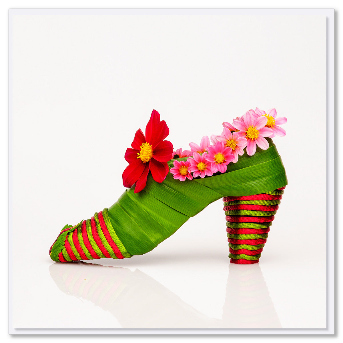 A charming dahlia shoe greeting greeting card from Golly Gosh Creations. Crafted from vibrant Dahlia blooms and verdant Flax foliage. Size 142 x 142 mm