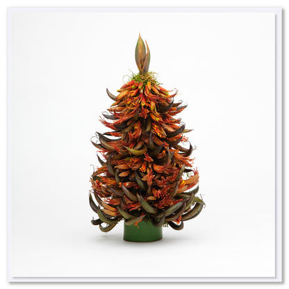 Decorative arrangement resembling a Christmas tree made from native New Zealand Flax flowers on a white background