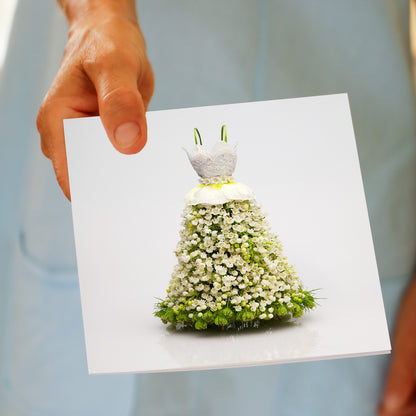 Golly Gosh Lace Bodice Dress greeting card held in hand, showing floral gown made entirely of white flowers with lace bodice and green details.