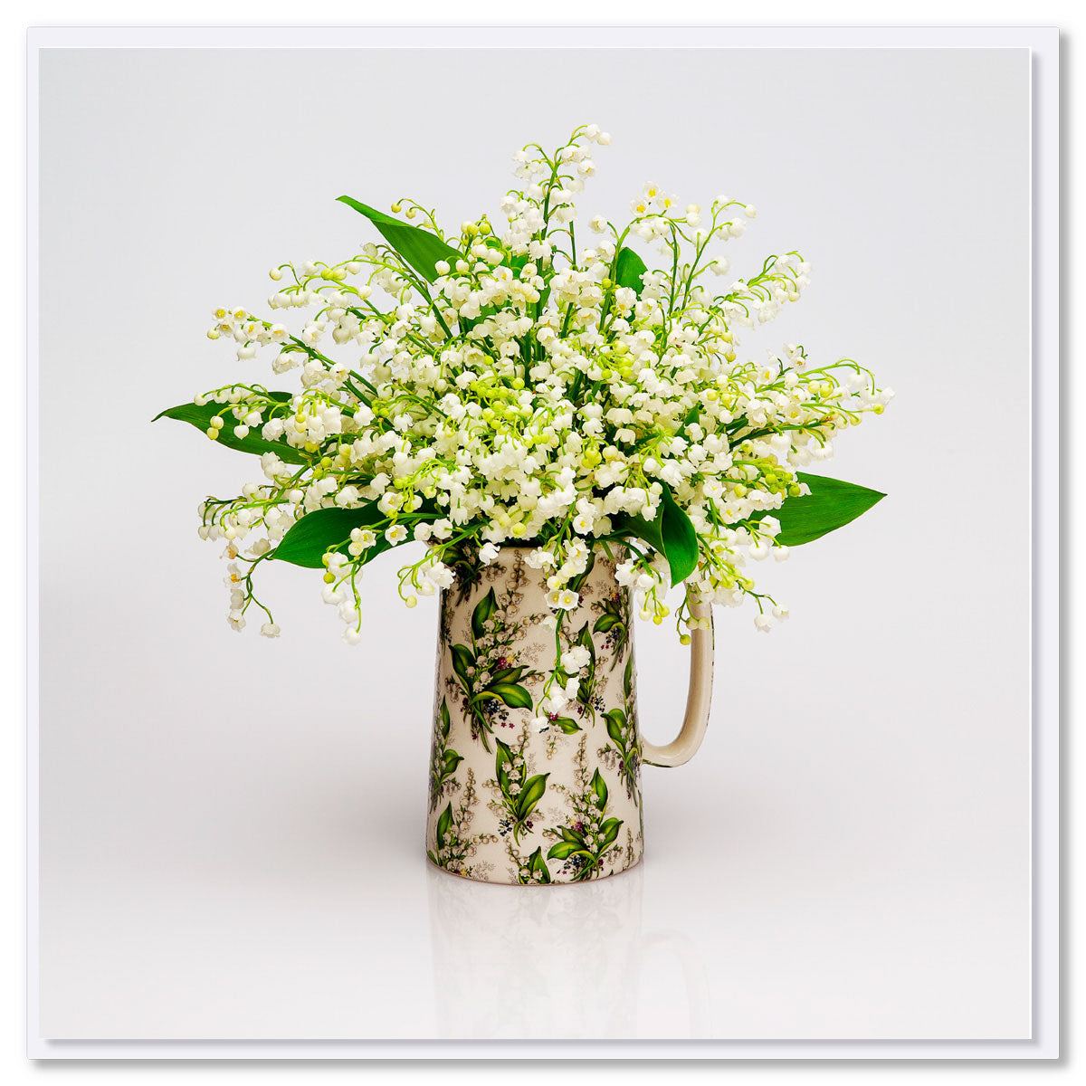 A lily of the valley jug greeting card from Golly Gosh Creations. Size 142 x 142 mm. Delicate white blooms arranged in a matching pretty jug.