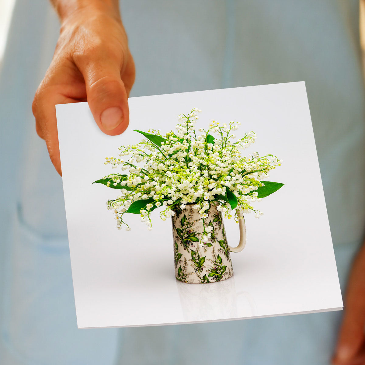 A hand held lily of the valley jug greeting card from Golly Gosh Creations. A generous square card with a pretty arrangement of delicate blooms.