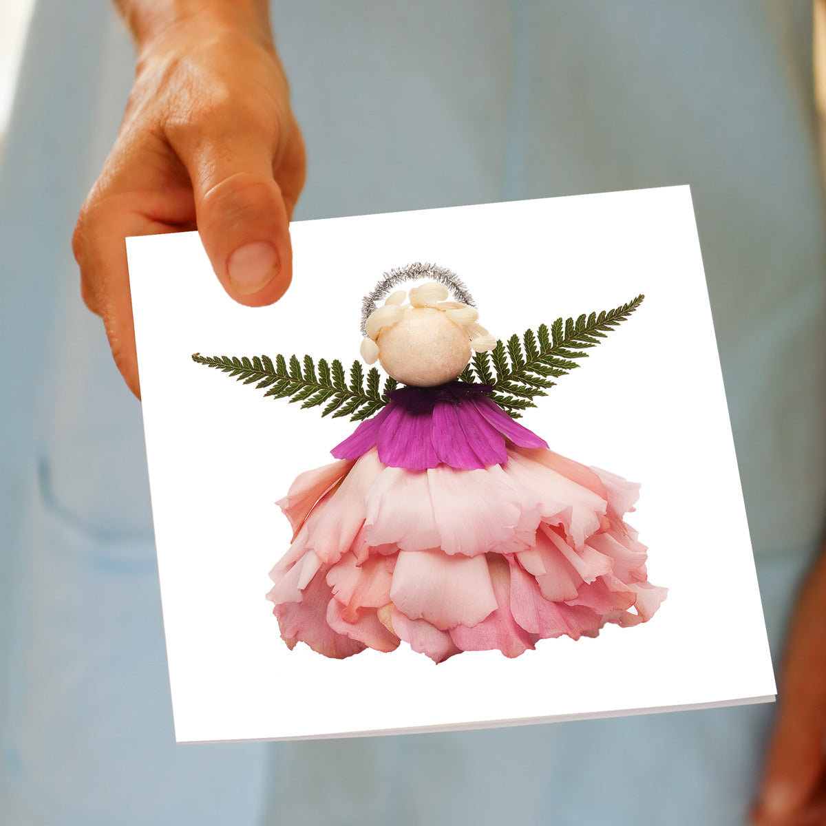 Back of Golly Gosh Pink Angel greeting card displaying the product image, blank inside note, description of the handcrafted Mother and Son artist collection, Golly Gosh branding, website and social details, and eco friendly certification.