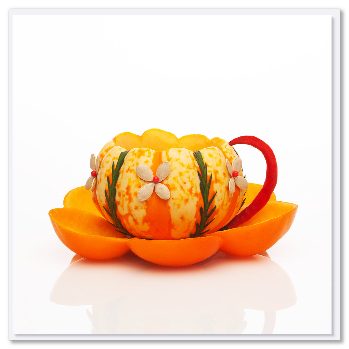 A pumpkin cup greeting card from Golly Gosh Creations. Created from bright pumpkin, fruits and seeds with a red chilli handle. Size 142 x 142 mm