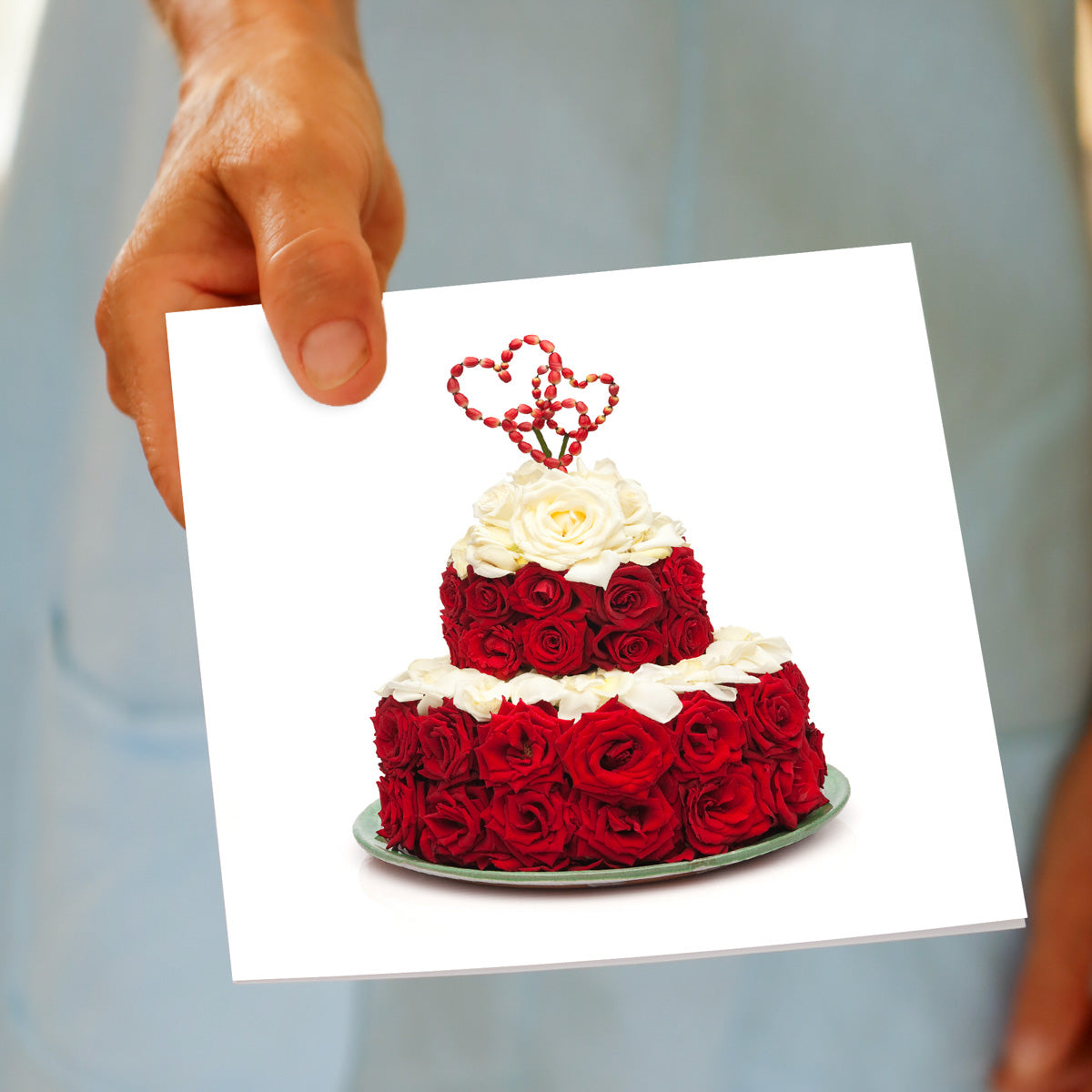 A hand held red rose heart greeting card by Golly Gosh Creations. This card is teared with luscious red roses and pure white rose petals. Size 142 x 142 mm.