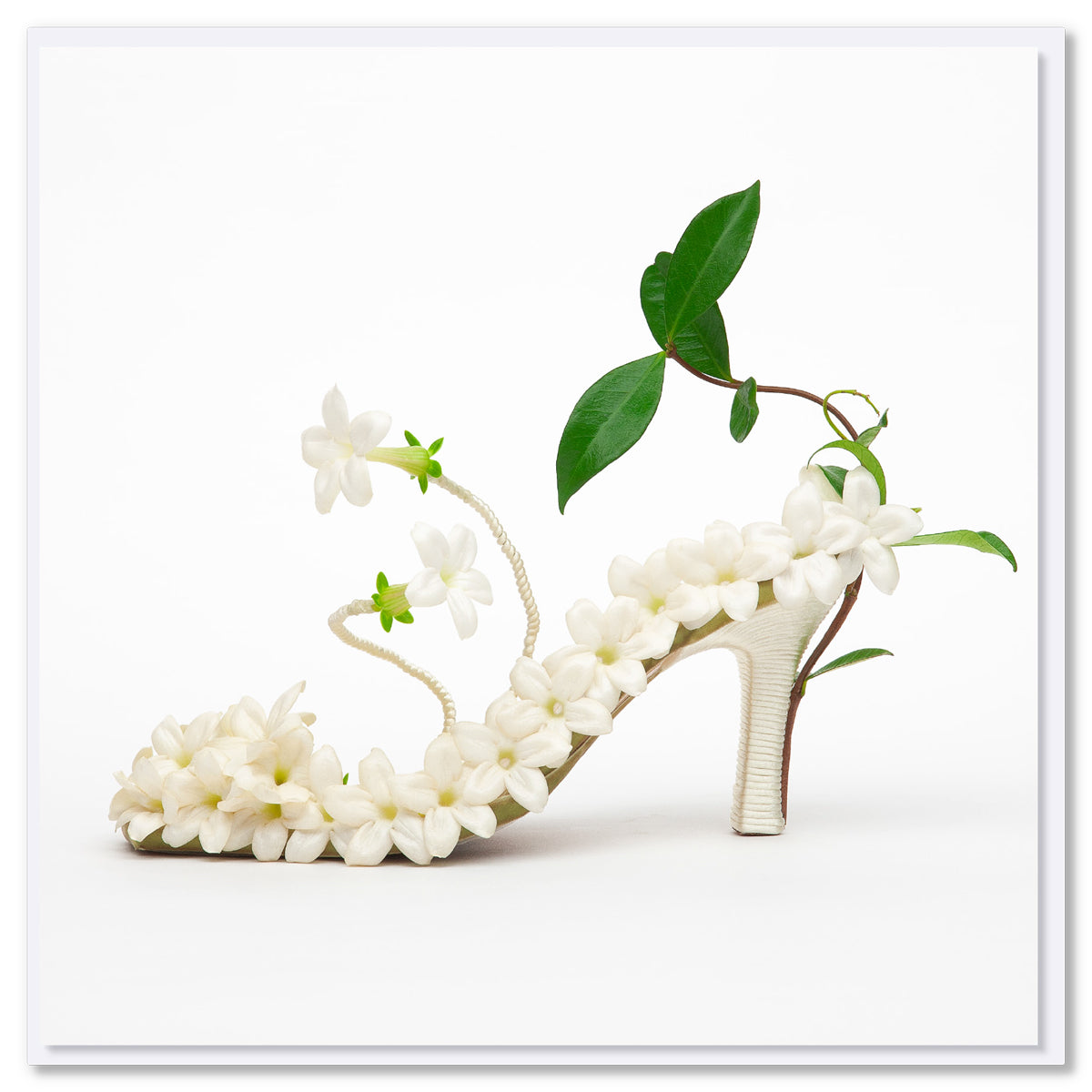 A charming stephanotis shoe greeting card found at Golly Gosh Creations. Size 142 x 142 mm. Created from white stephanotis blooms on a white background.