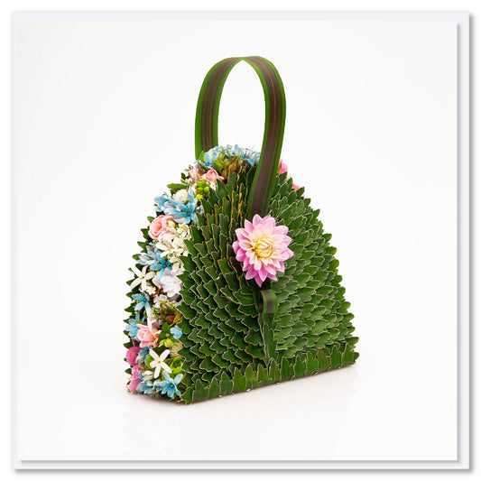 A tweedia bag greeting card from Golly Gosh Creations. Size 142 x 142 mm. Crafted from dainty tweedia flowers and leaves.