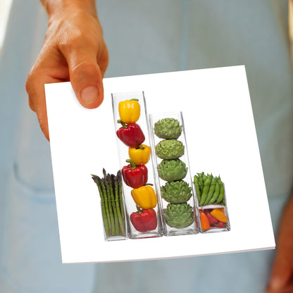 A veg vases greeting card being held by hand. This colourful, generous square card is found at Golly Gosh Creations. 